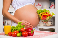 Pregnant woman preparing vegetables
