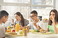 students having lunch in school cafeteria