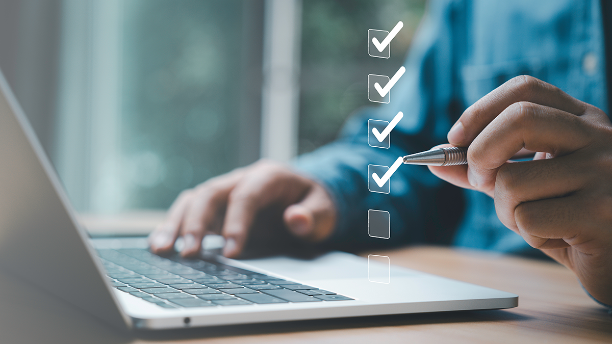 image of a person checking off a list on their laptop