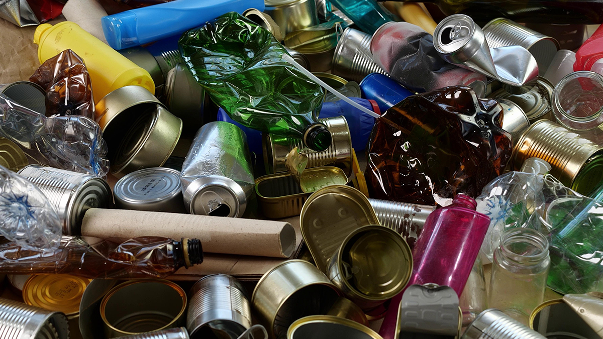 Image of recyclables including glass, metal and cardboard