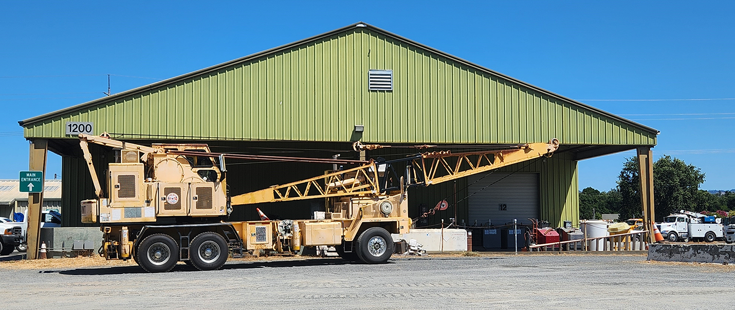 image of a large vehicle maintenance building with a construction truck in front