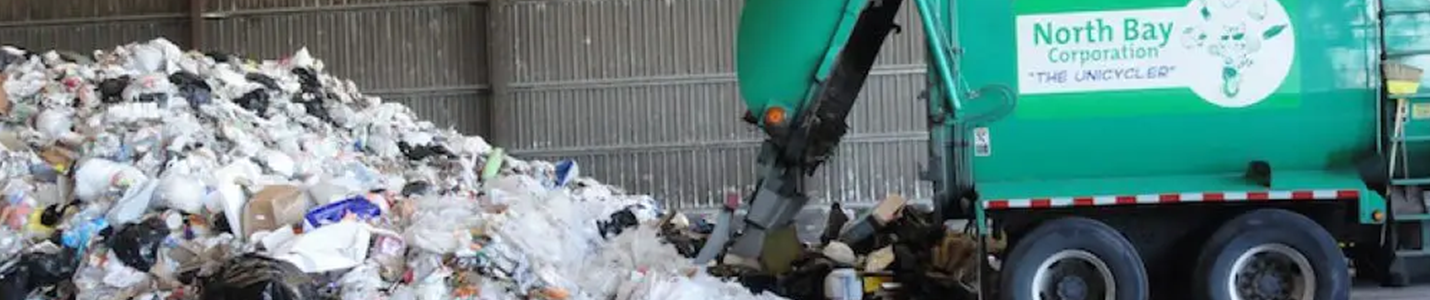 image of a trash next to a plastic trash bin with wheels